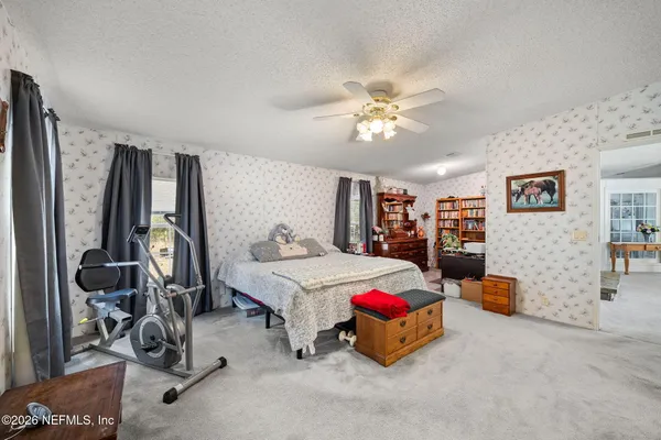a bedroom with furniture and a chandelier