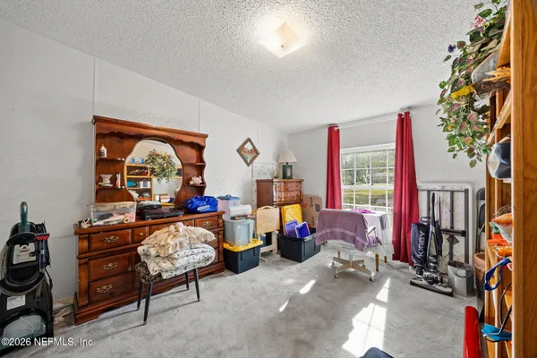 a living room with lots of furniture and a floor to ceiling window
