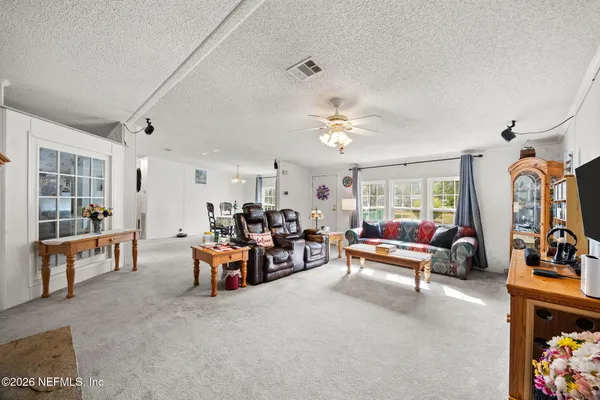 a living room with furniture and a chandelier