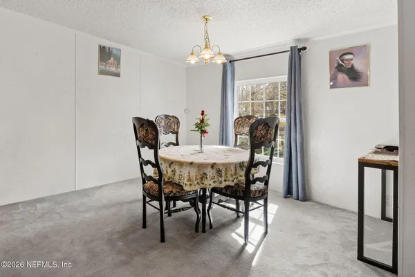 a dining room with furniture and window