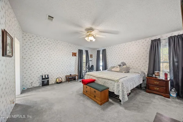 a bedroom with a bed and a chandelier