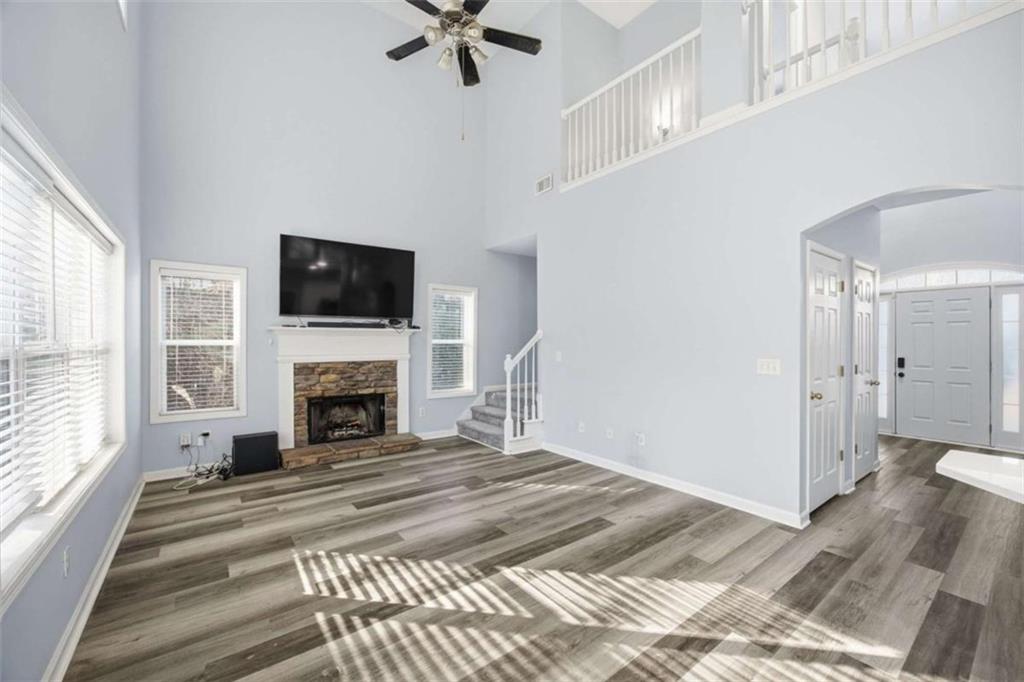 44 Creekside Way Hiram, GA 30141 - Photo 11 of 31 a view of a livingroom with a fireplace a ceiling fan and wooden floor
