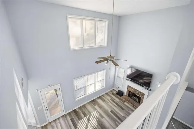 a living room with furniture a flat screen tv and a window