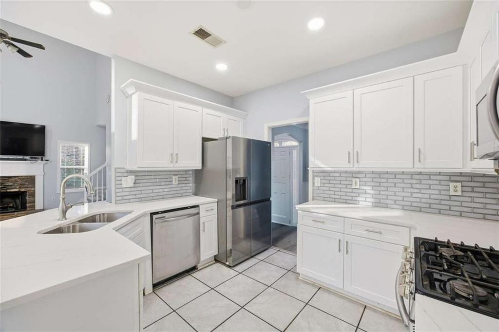 44 Creekside Way Hiram, GA 30141 - Photo 16 of 31 a kitchen with stainless steel appliances a stove sink and refrigerator