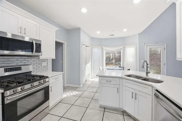 a kitchen with a sink stove and microwave