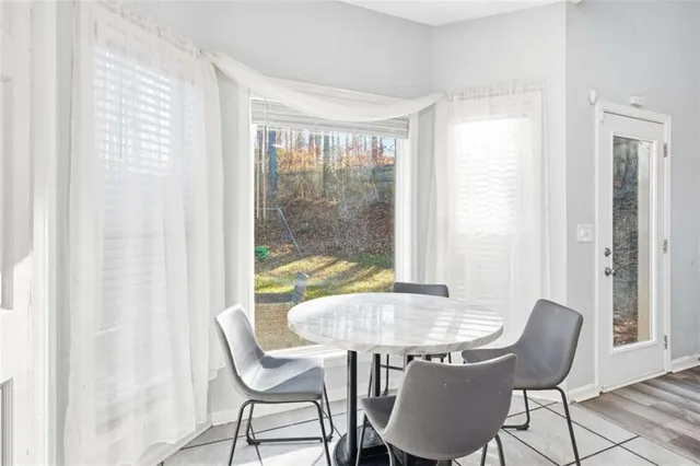a dining room with furniture and window