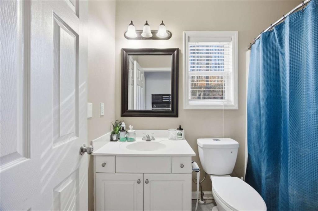 44 Creekside Way Hiram, GA 30141 - Photo 19 of 31 a bathroom with a toilet sink and mirror