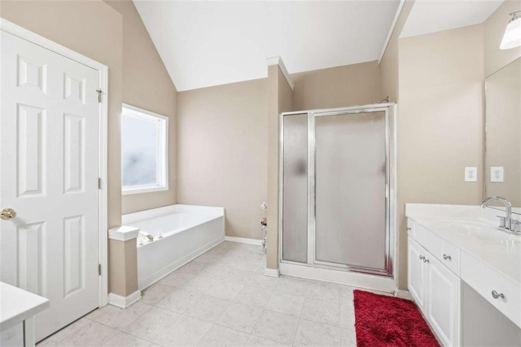 44 Creekside Way Hiram, GA 30141 - Photo 24 of 31 a bathroom with a bathtub sink and mirror