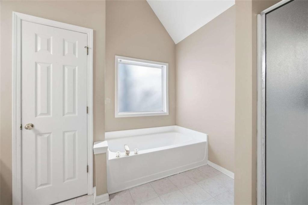 44 Creekside Way Hiram, GA 30141 - Photo 25 of 31 a bathroom with a bathtub and shower