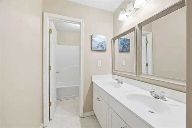 a bathroom with a double vanity sink mirror and double