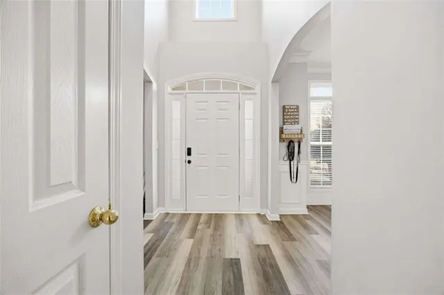 a view of a hallway with wooden floor and closet