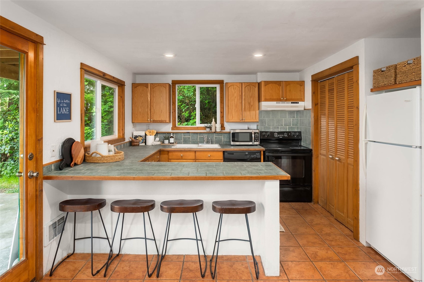 1321 Southwest Lake Roesiger Road Snohomish, WA 98290 - Photo 8 of 38 a kitchen with stainless steel appliances granite countertop a stove a refrigerator a table and chairs