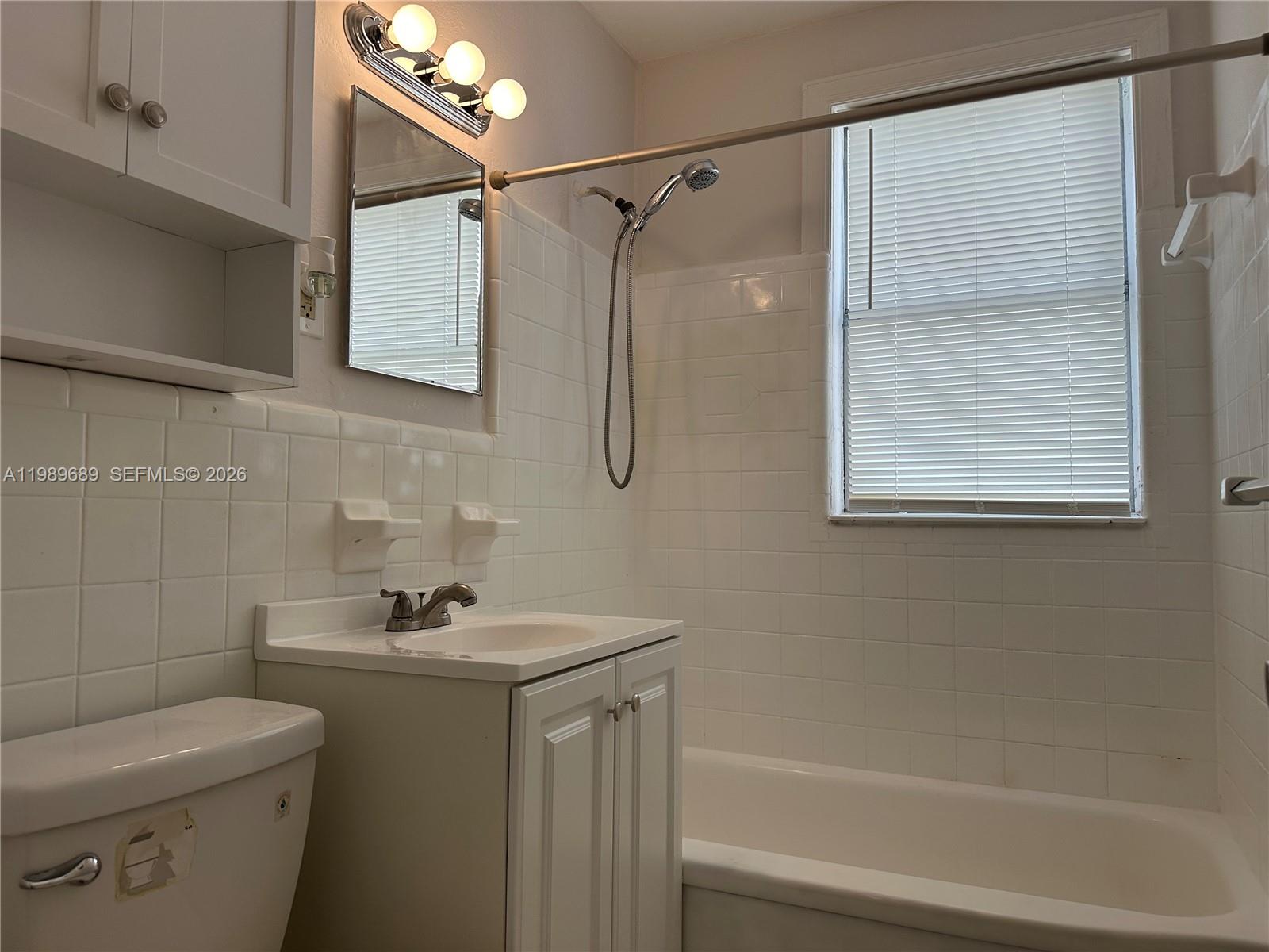 1441 Northeast 134th Road, Unit 2 North Miami, FL 33161 - Photo 16 of 16 a bathroom with a sink a toilet and shower