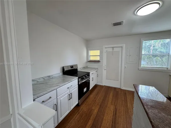 a kitchen with a cabinets and wooden floor