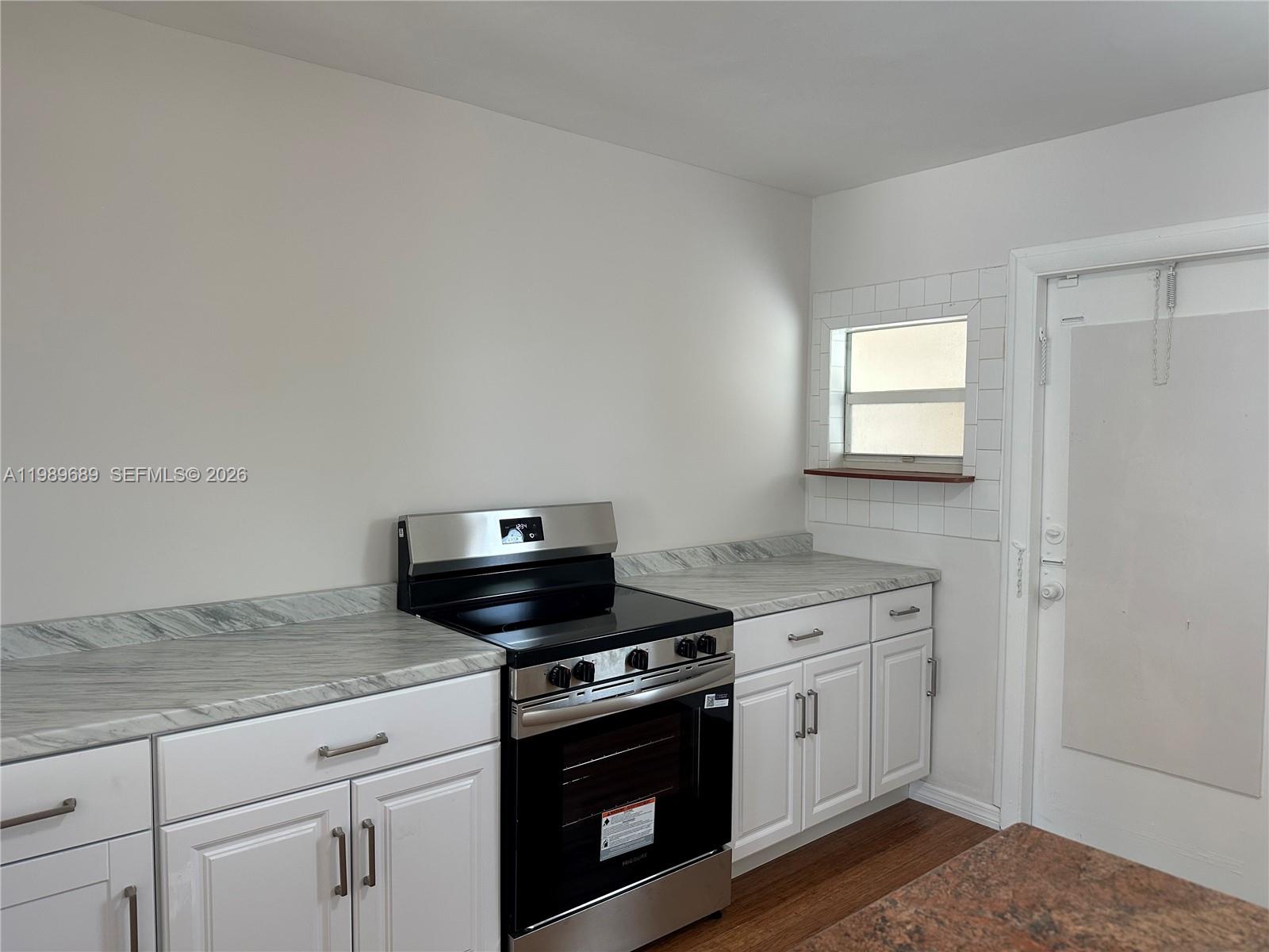 1441 Northeast 134th Road, Unit 2 North Miami, FL 33161 - Photo 4 of 16 a kitchen with a stove and a sink