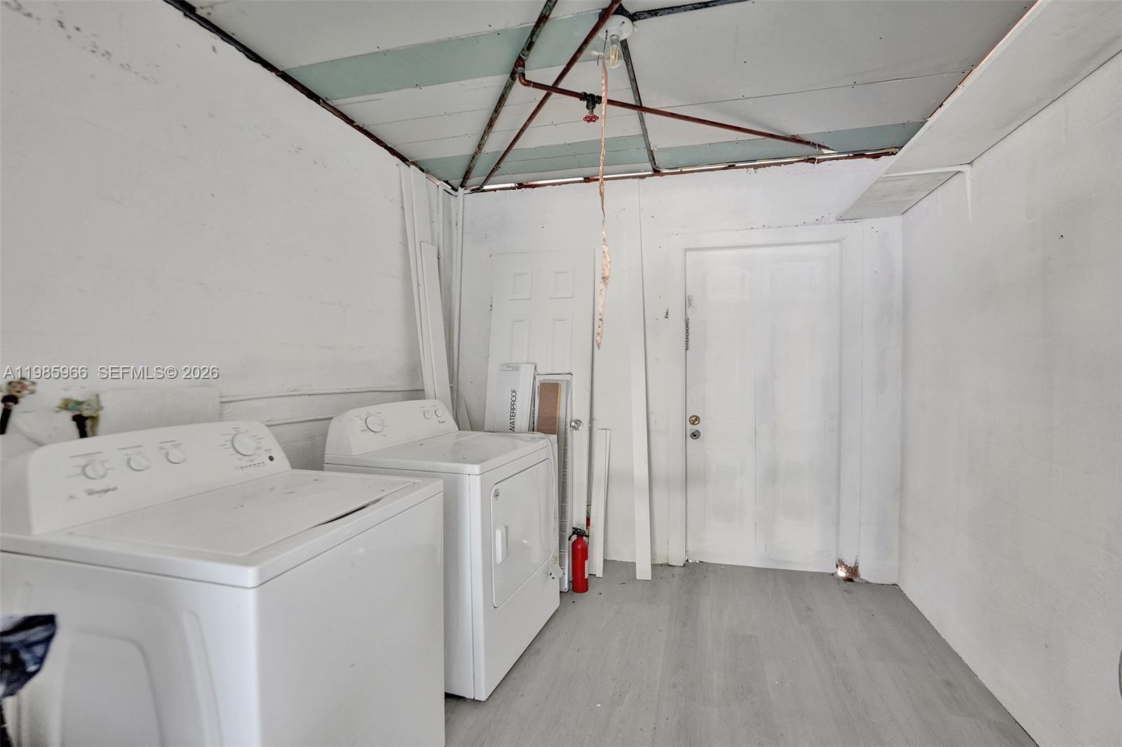 5657 Grant Street, Unit 4 Hollywood, FL 33021 - Photo 11 of 13 a utility room with dryer and washer