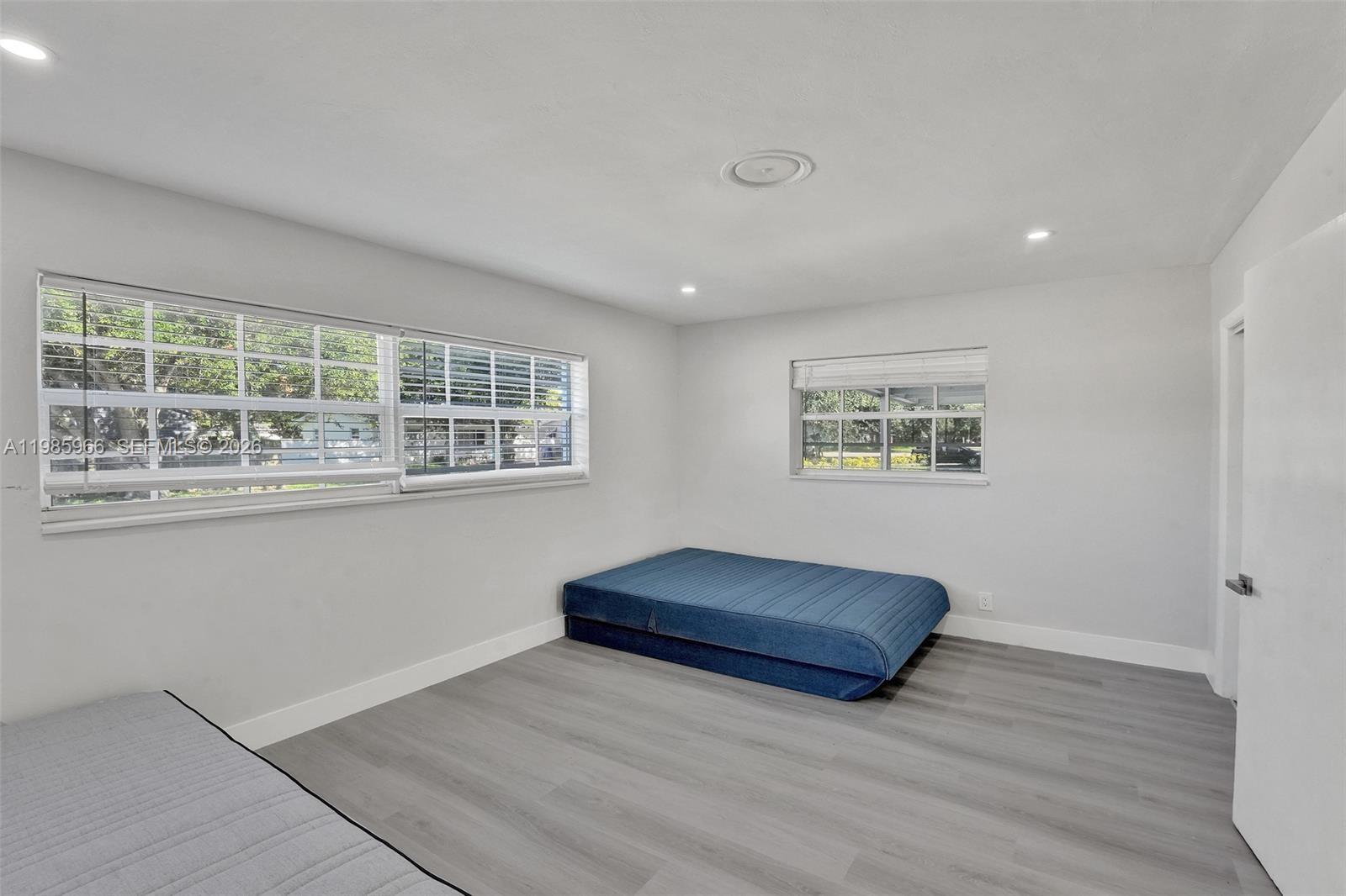 5657 Grant Street, Unit 4 Hollywood, FL 33021 - Photo 3 of 13 a living room with a bed and a window
