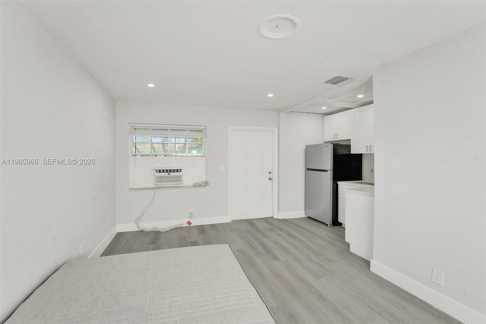 5657 Grant Street, Unit 4 Hollywood, FL 33021 - Photo 7 of 13 a bedroom with a bed and a television