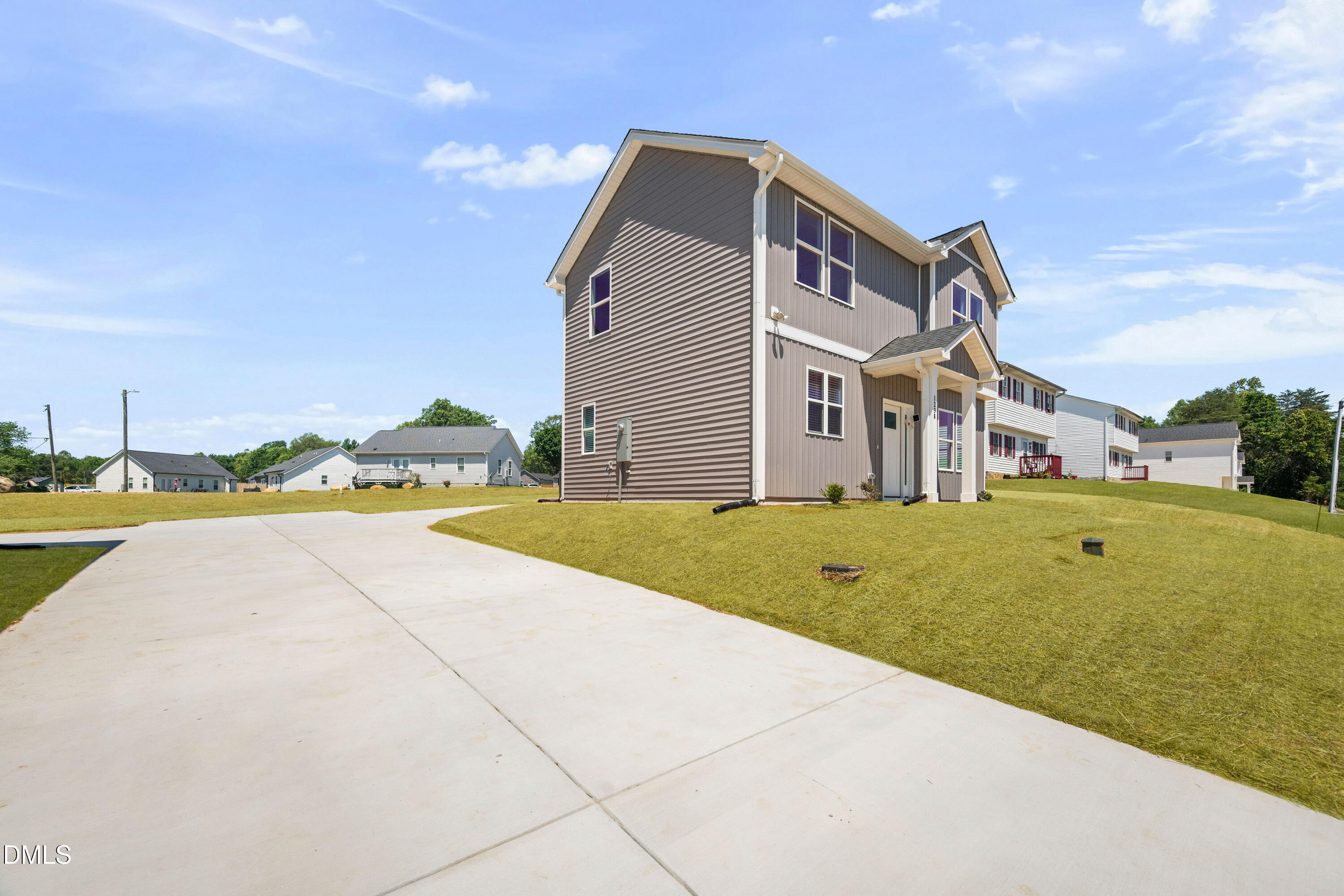 1238 Hurdle Mills Road Roxboro, NC 27573 - Photo 7 of 50 a front view of a house with a yard and trees