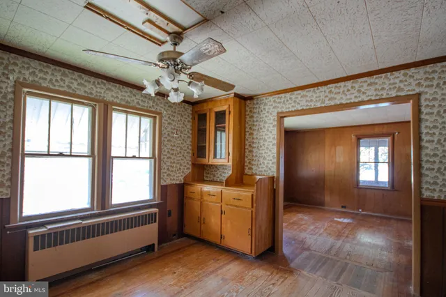 a view of a livingroom with a window and chandelier