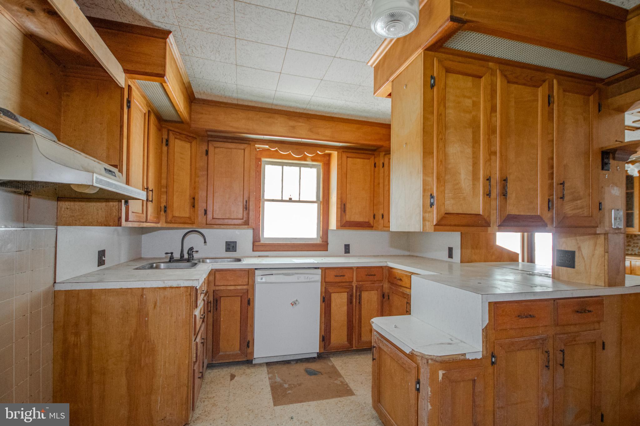 605 4th Street Sharptown, MD 21861 - Photo 14 of 38 a kitchen with a sink a window and cabinets