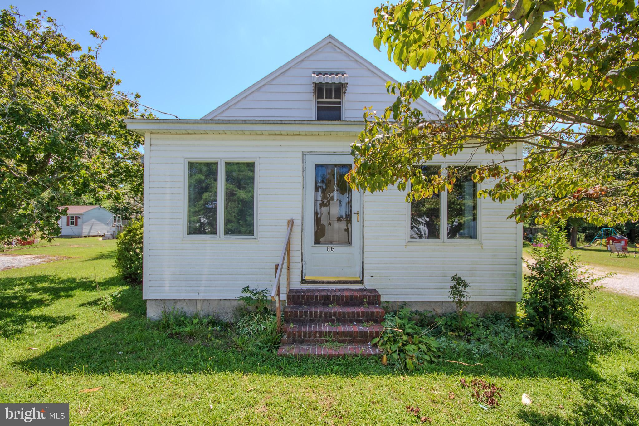 605 4th Street Sharptown, MD 21861 - Photo 2 of 38 a front view of a house with a garden