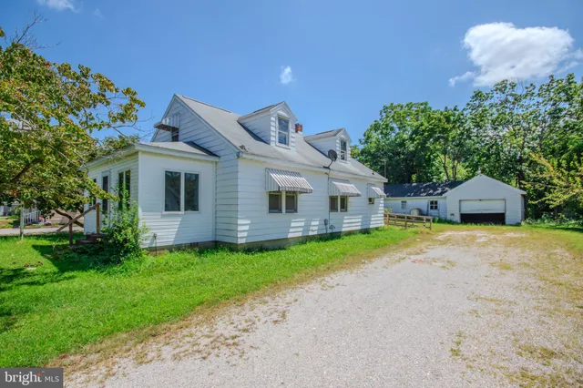 a front view of a house with a garden and yard