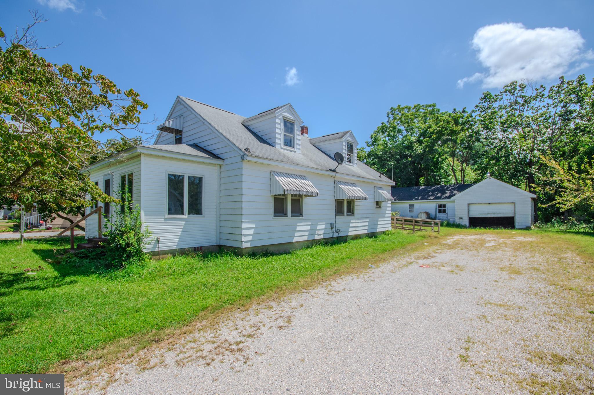 605 4th Street Sharptown, MD 21861 - Photo 3 of 38 a front view of a house with a garden and yard