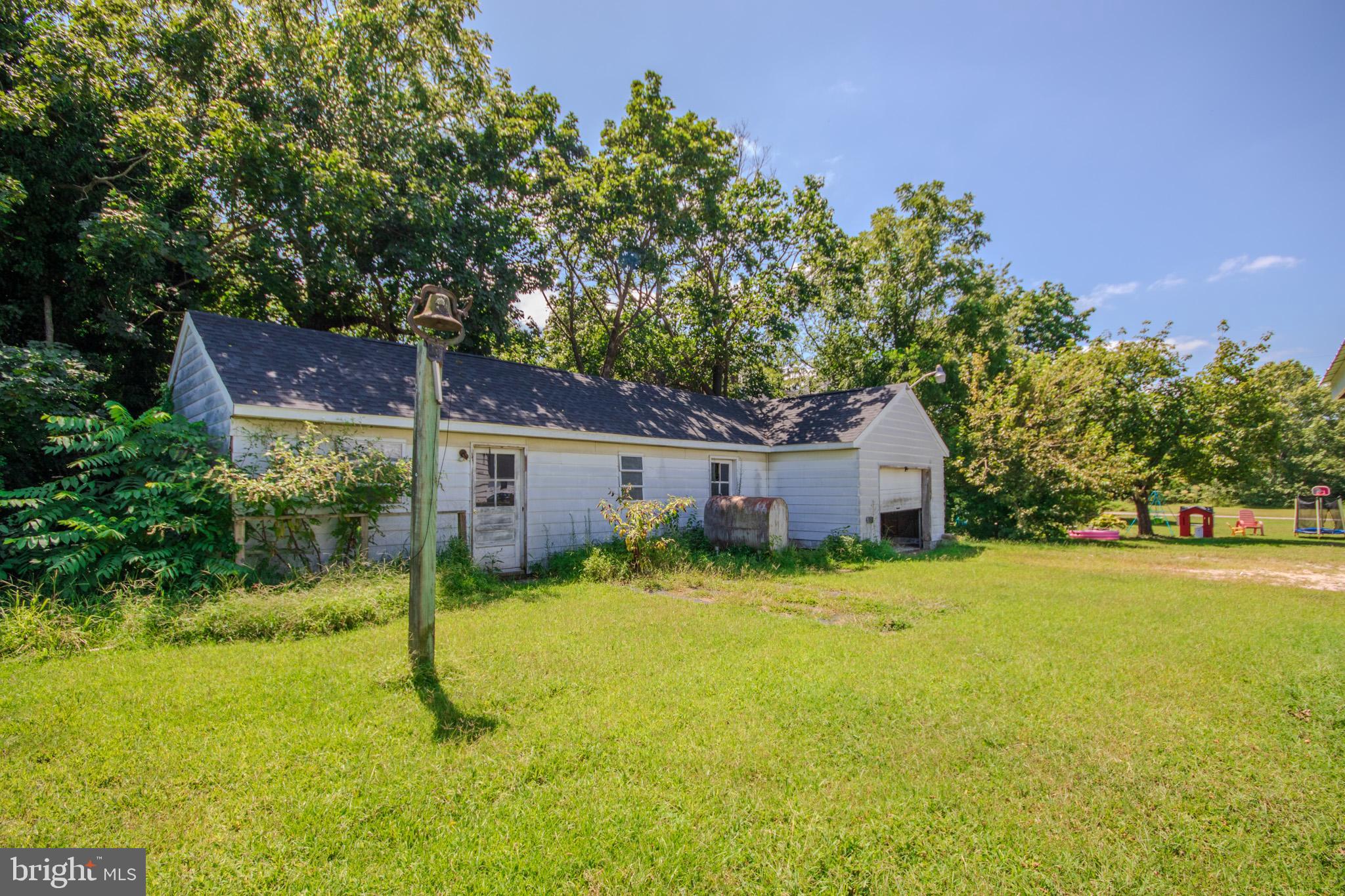 605 4th Street Sharptown, MD 21861 - Photo 37 of 38 a backyard of a house with yard and outdoor seating