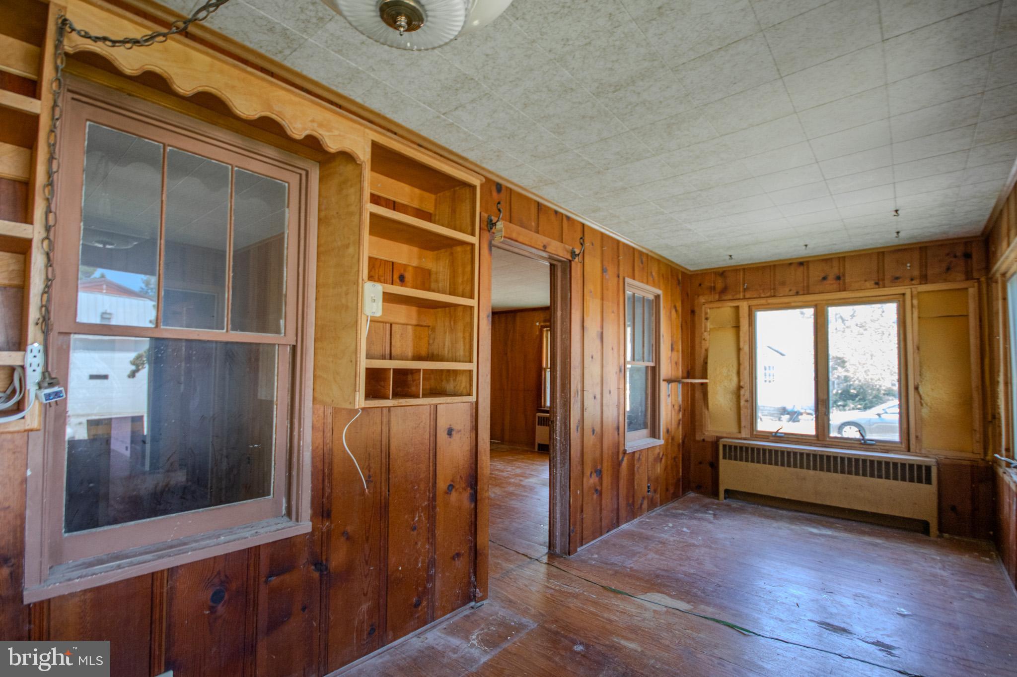 605 4th Street Sharptown, MD 21861 - Photo 7 of 38 an empty room with wooden floor and windows