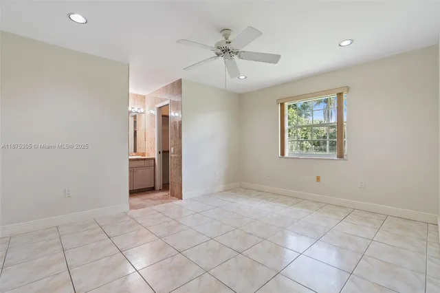 a view of a livingroom with a ceiling fan and window