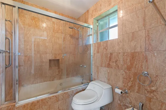 a bathroom with a toilet and shower