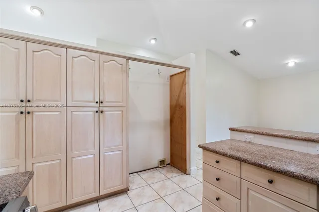 a hallway with white cabinets