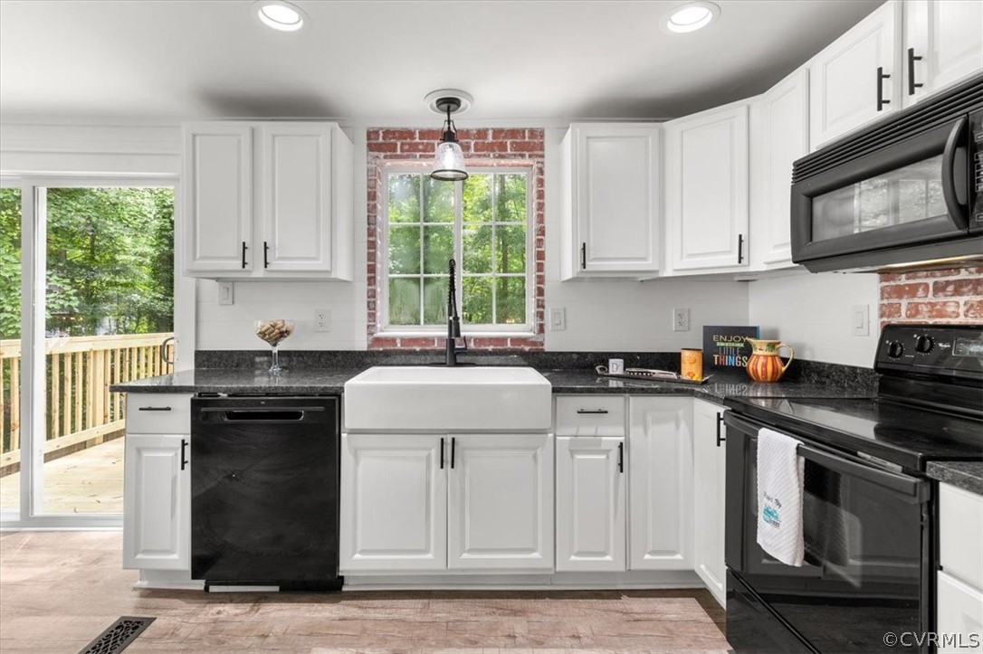 10501 White Rabbit Road Richmond, VA 23235 - Photo 13 of 49 a kitchen with stainless steel appliances granite countertop a stove a sink and a microwave