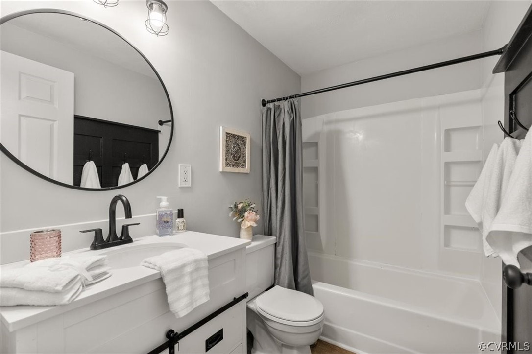 10501 White Rabbit Road Richmond, VA 23235 - Photo 19 of 49 a bathroom with a sink a toilet and a mirror