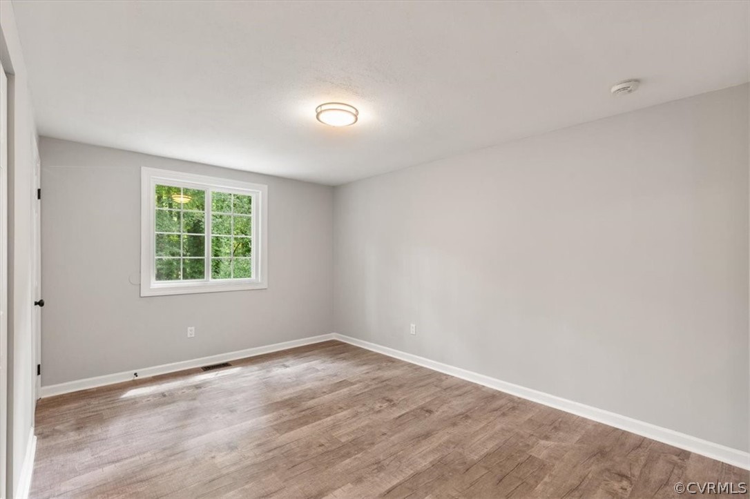 10501 White Rabbit Road Richmond, VA 23235 - Photo 24 of 49 wooden floor in an empty room with a window