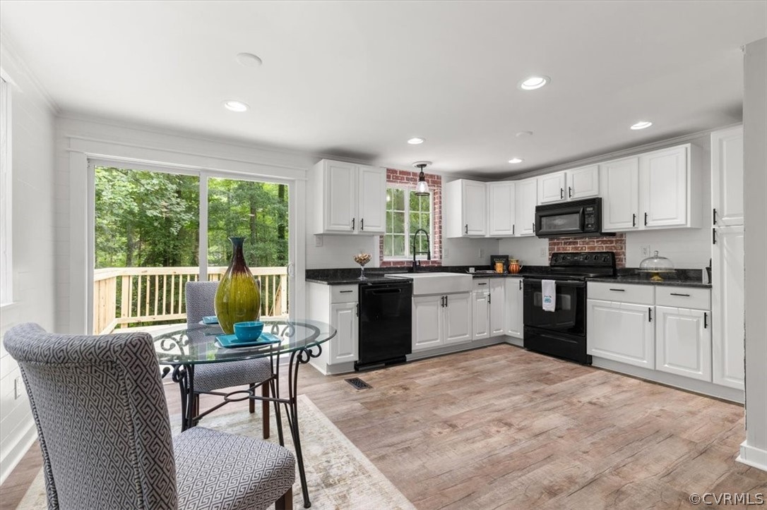 10501 White Rabbit Road Richmond, VA 23235 - Photo 10 of 49 a kitchen with a stove a sink a dining table and chairs