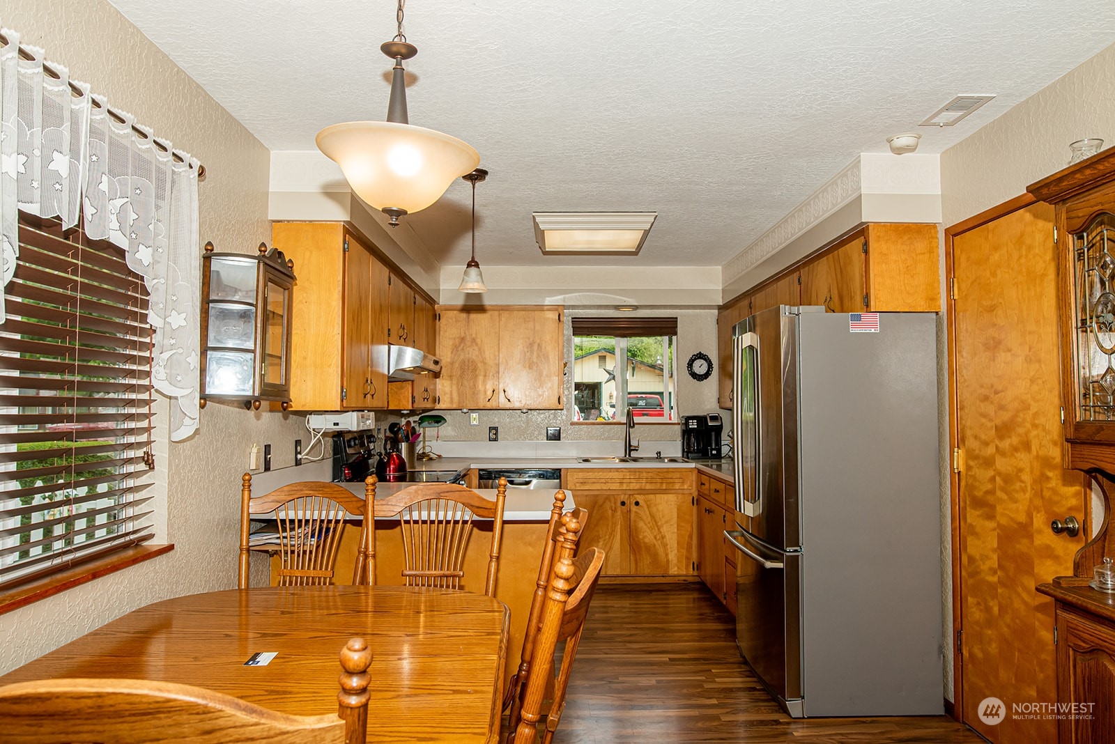 1003 Hilltop Road Winlock, WA 98596 - Photo 9 of 28 a living room with stainless steel appliances furniture windows and a chandelier