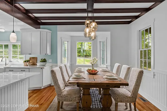 a kitchen with stainless steel appliances granite countertop a sink window and wooden floor