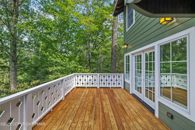 a large kitchen with stainless steel appliances wooden cabinets a sink and a stove