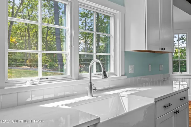 a bathroom with a sink a toilet and a window