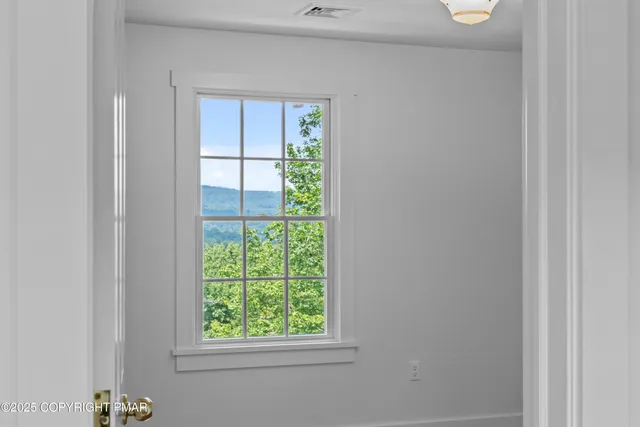 a front view of a house with a yard and trees