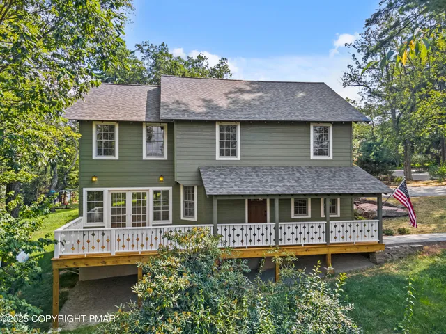 an aerial view of a house with swimming pool and garden view