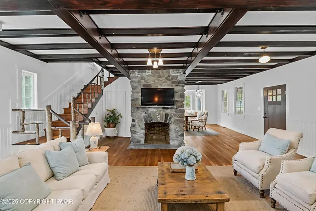a view of empty room with wooden floor and fireplace