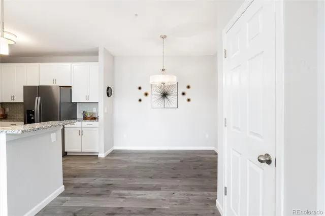 a kitchen with cabinets and wooden floor