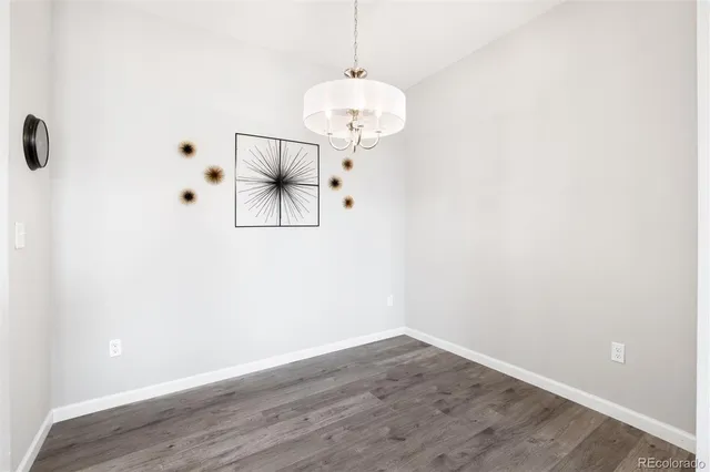 a view of a room with wooden floor and white walls