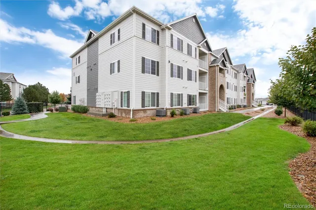 a front view of a building with a yard