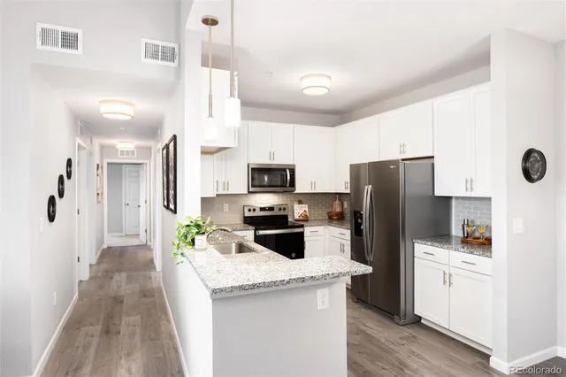 a kitchen with a refrigerator a sink and dishwasher