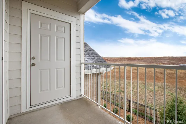 a building outdoor space with patio furniture and potted plants