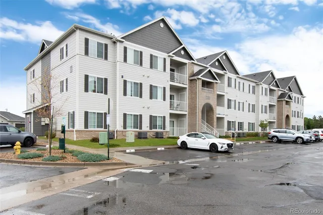 a car parked in front of a white building